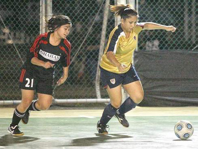 Agnes Rumbaoa, right, of dck Masters tries to clear the ball away from the goal in a Guam Football Association Bud Light Women*s Futsal League game against Guahan last night at the GFA court one in Harmon. (Patrick Camacho/For Pacific Daily News)